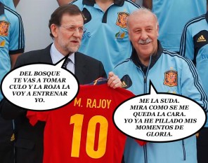 Spain's PM Rajoy holds a Spanish national soccer shirt with his name during his visit to the Soccer City area in Las Rozas